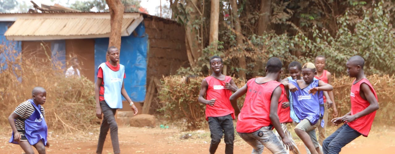 Paul playing football with his friends
