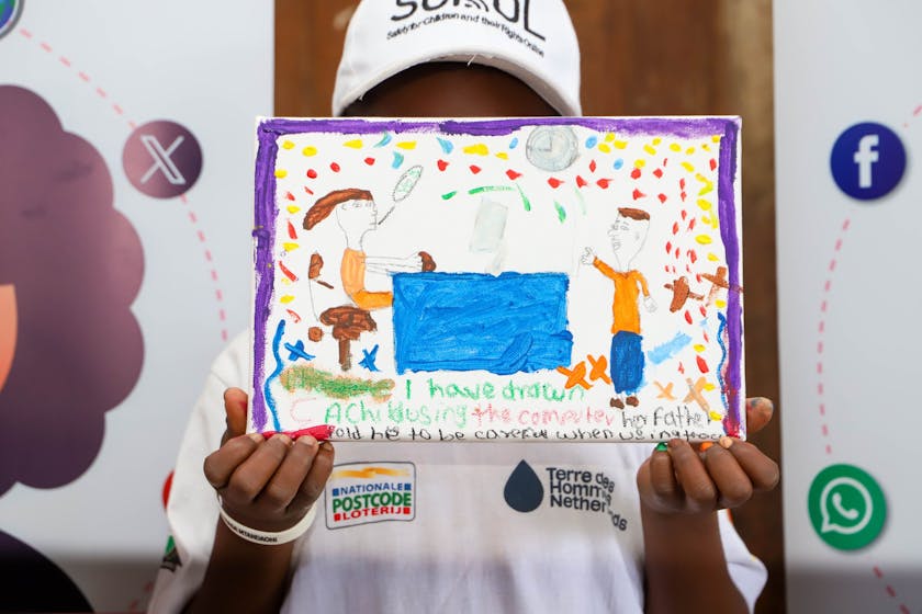 child holding drawing during event is kisumu