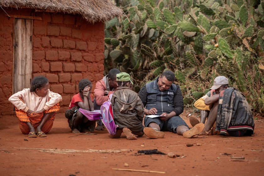 Lima, a staff member from Terre des Hommes Netherlands, interviews Mavitrika, 6, and her older brother Mahefa, 11 the two children of Mara, a former mica miner. Photo credit: Safidy Andrianantenaina