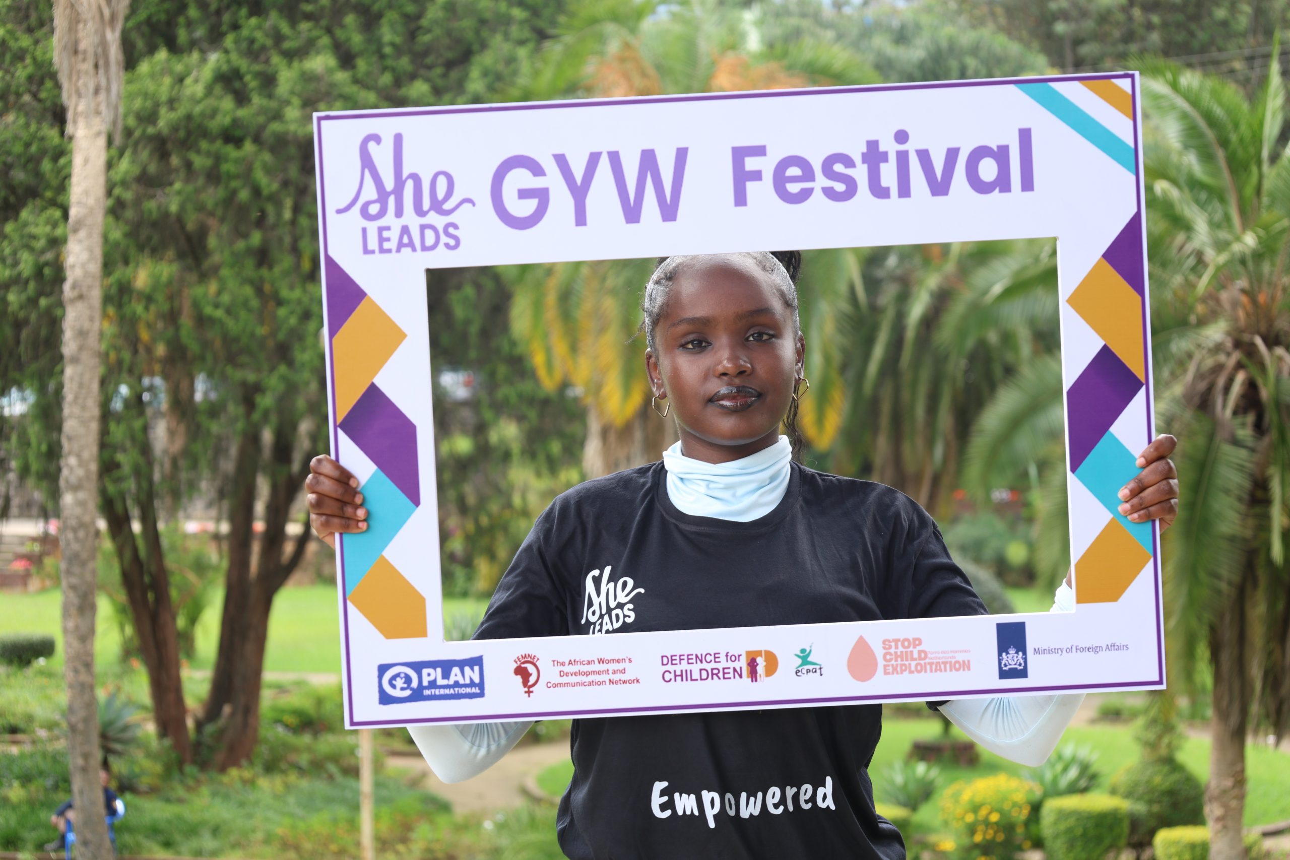 Banchiamlak, 19 years old, She Leads Advocate in Ethiopia, holding GYW Festival photo frame at the 