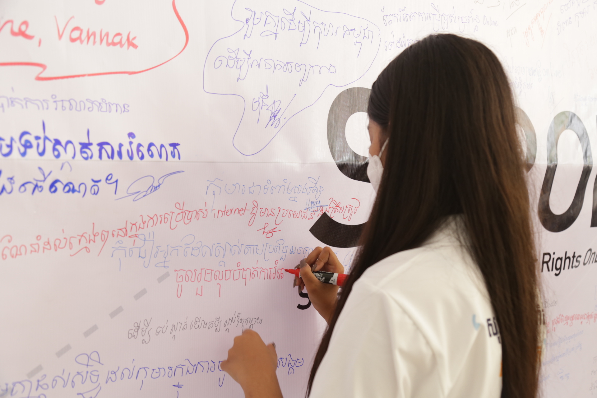 Girl writing ideas about the SCROL programme