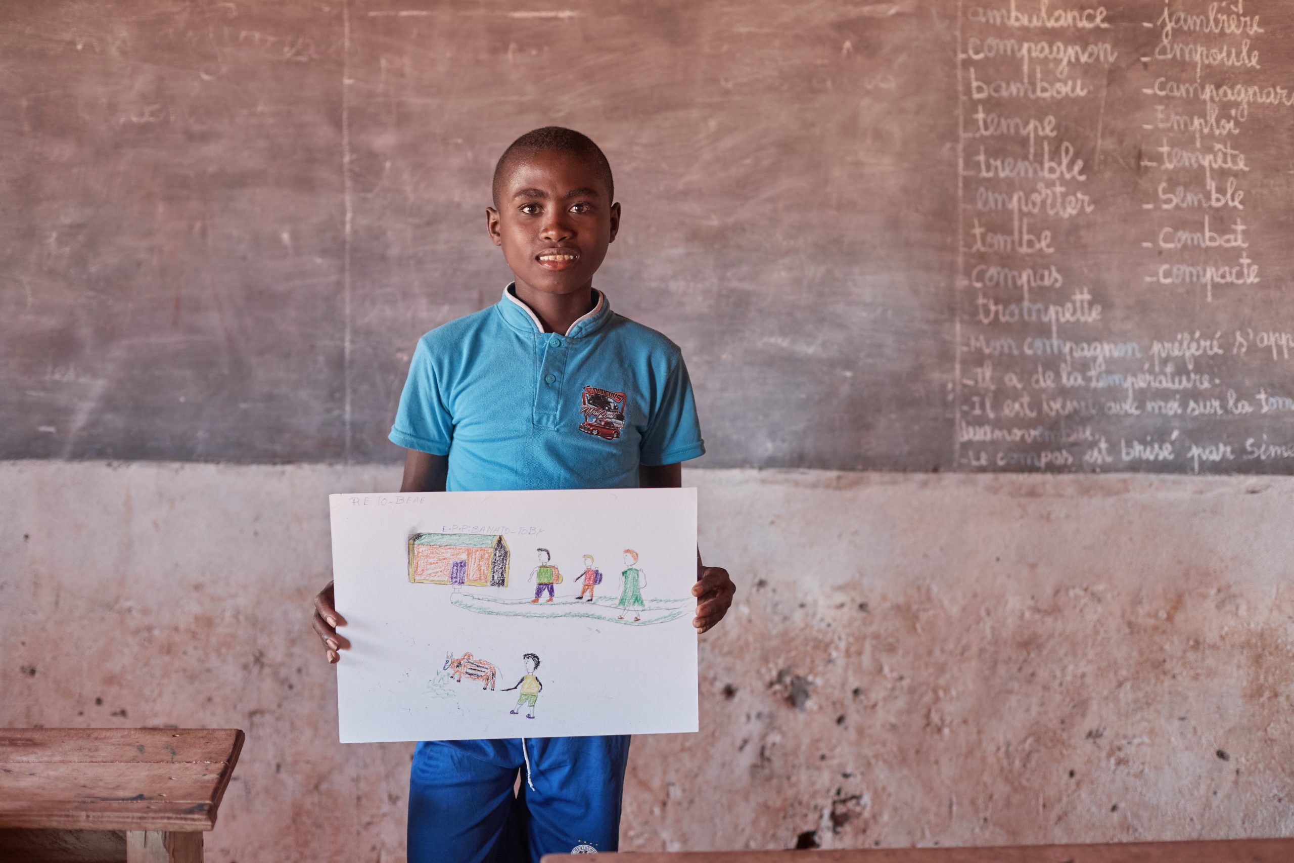 Photo: Messi holding a drawing depicting that children should going to school and not herd cattles