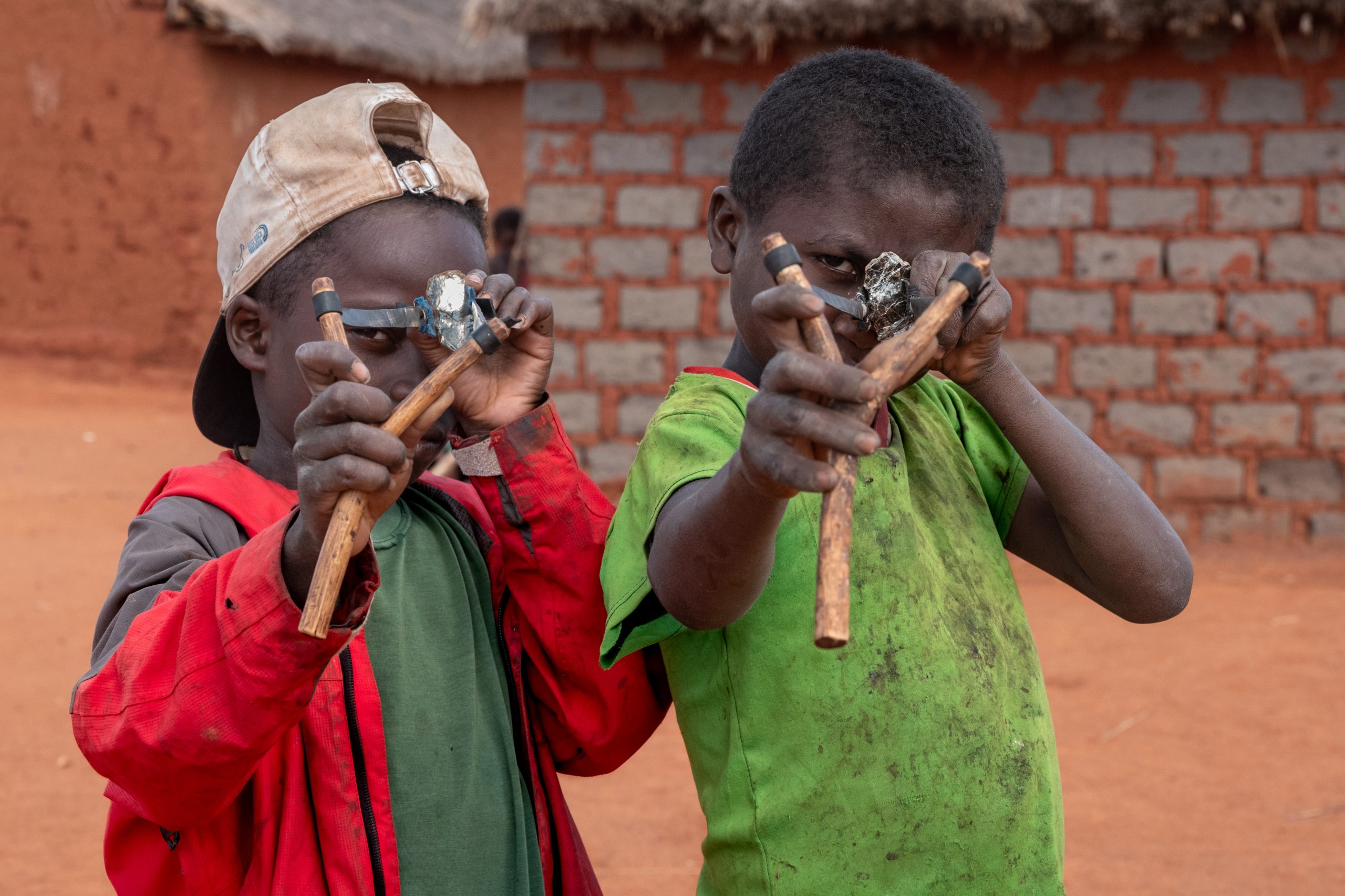 Photo: Tsiry, 8, and Fety, 13, proudly show off their favorite toys, slingshots they made themselves. Photo credit: Safidy Andrianantenaina